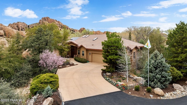 4710 Echo Canyon Pl, Prescott, AZ 86301 - view of front of house featuring a tile roof, a garage, driveway, roof mounted solar panels, and stucco siding