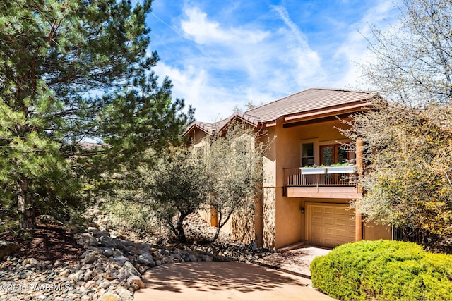 4710 Echo Canyon Pl, Prescott, AZ 86301 - view of front of house featuring a garage, stucco siding, a tiled roof, and a balcony