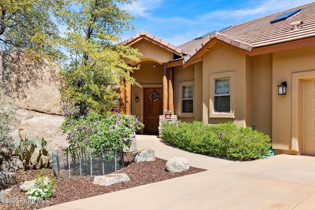 4710 Echo Canyon Pl, Prescott, AZ 86301 - property entrance featuring stucco siding, a garage, driveway, and a tile roof
