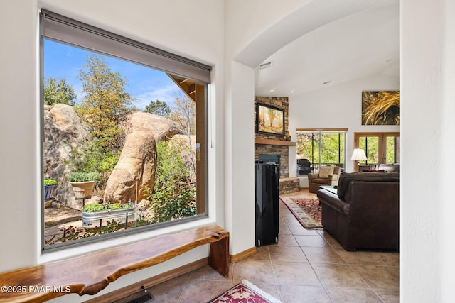 4710 Echo Canyon Pl, Prescott, AZ 86301 - interior space featuring a fireplace, light tile patterned floors, high vaulted ceiling, visible vents, and arched walkways