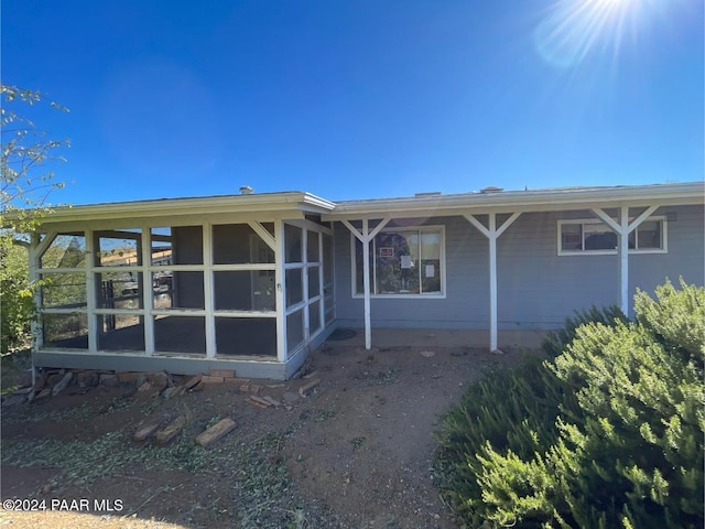 back of house featuring a sunroom