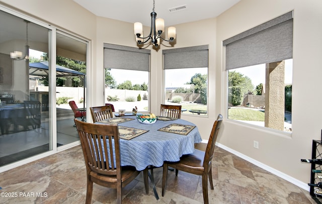 6582 E Farmstead Rd, Prescott Valley, AZ 86314 - dining space featuring a chandelier and stone finish floors