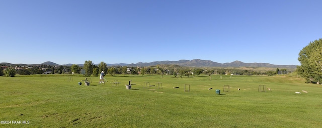 view of community featuring a lawn and a mountain view