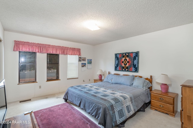 carpeted bedroom featuring a textured ceiling