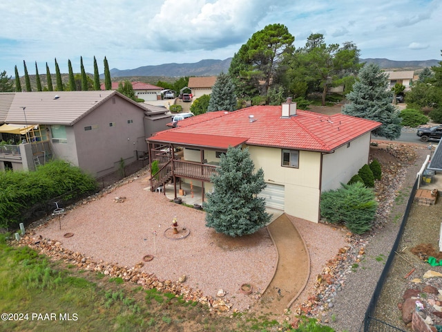 rear view of house featuring a mountain view and a garage