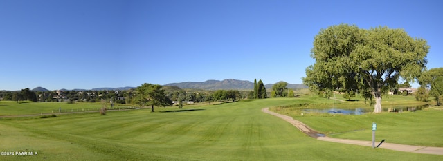 view of home's community with a lawn and a water and mountain view