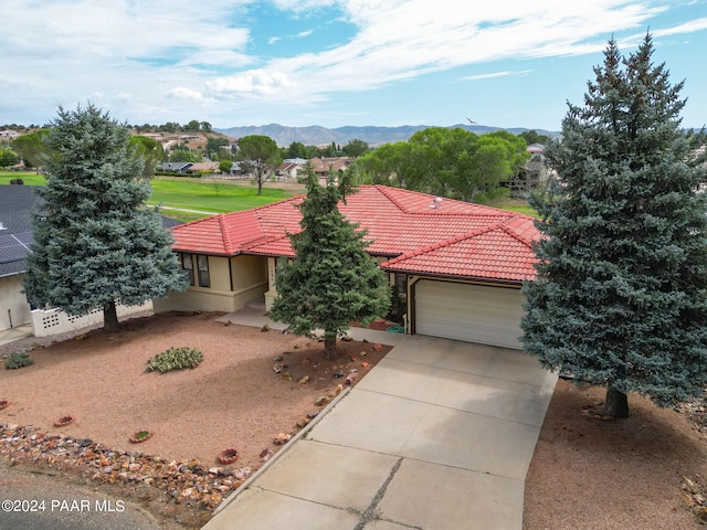 view of front of house featuring a mountain view and a garage