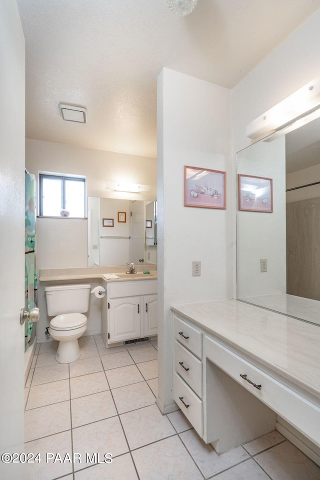 bathroom featuring tile patterned floors, vanity, and toilet