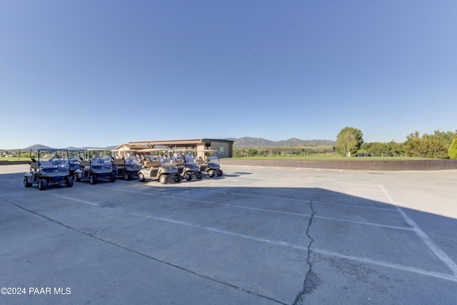 view of vehicle parking featuring a mountain view