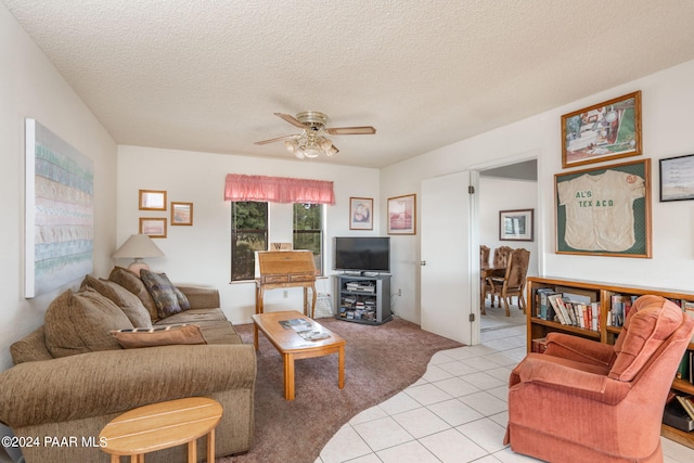 tiled living room featuring ceiling fan and a textured ceiling