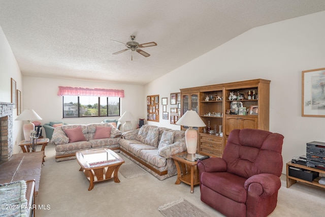 living room featuring a brick fireplace, a textured ceiling, light colored carpet, vaulted ceiling, and ceiling fan