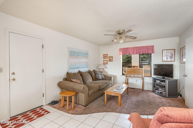 living room with light tile patterned floors, a textured ceiling, and ceiling fan