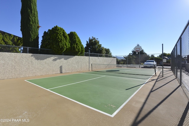 view of sport court with basketball hoop