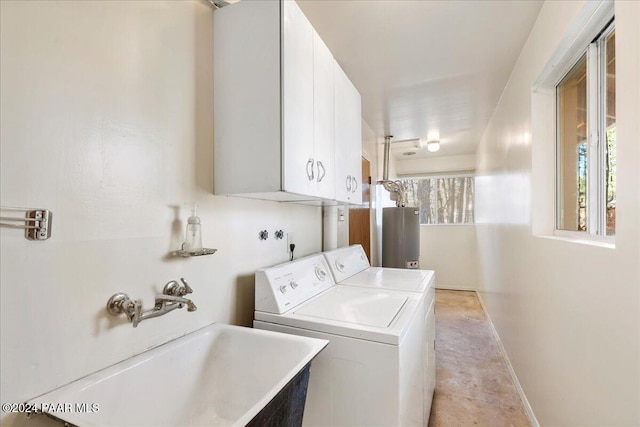 washroom with cabinets, sink, washer and dryer, light tile patterned floors, and water heater