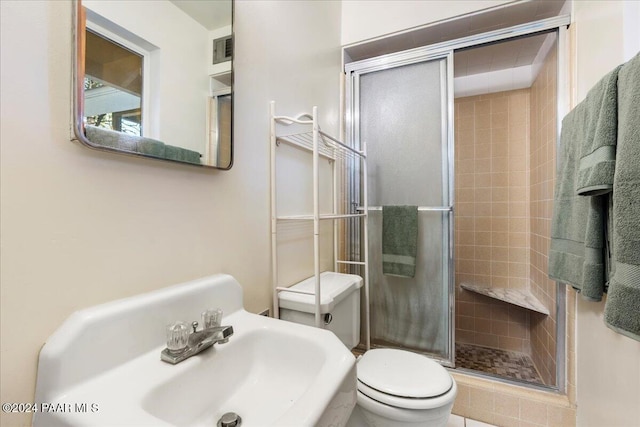 bathroom with toilet and walk in shower