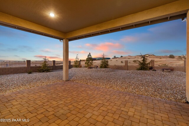 view of patio terrace at dusk