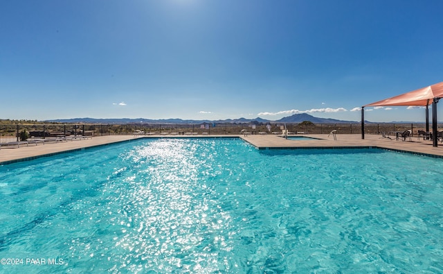 view of swimming pool with a mountain view