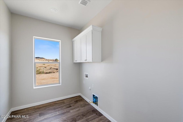 washroom with cabinets, dark hardwood / wood-style flooring, and hookup for a washing machine