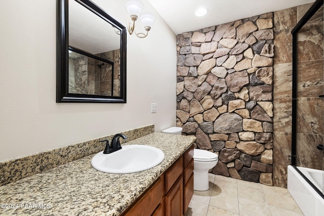 full bathroom with tile patterned floors, toilet, combined bath / shower with glass door, and vanity