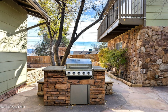 view of patio / terrace with area for grilling, a balcony, and grilling area