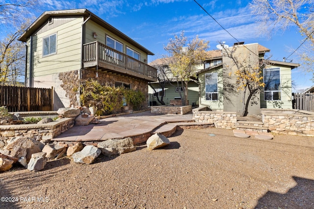 back of property with a patio area and a balcony