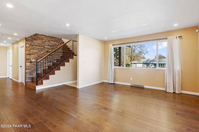 unfurnished living room featuring hardwood / wood-style flooring