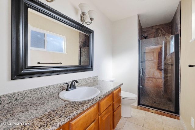 bathroom with tile patterned flooring, vanity, an enclosed shower, and toilet