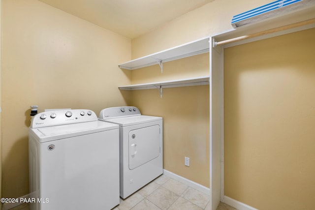 washroom with light tile patterned floors and washing machine and clothes dryer