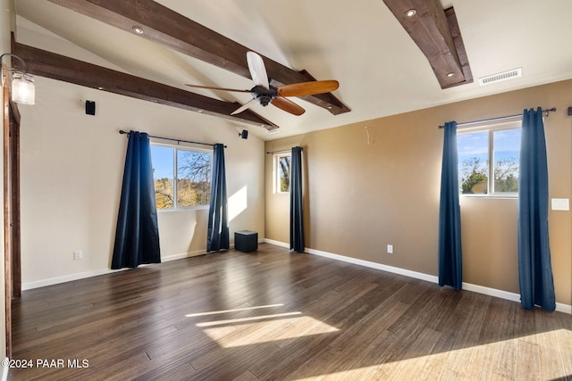 empty room with vaulted ceiling with beams, ceiling fan, dark wood-type flooring, and a healthy amount of sunlight