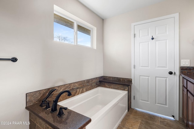 bathroom featuring vanity and a tub