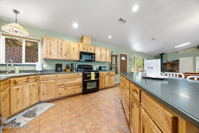 kitchen with dark countertops, visible vents, light brown cabinets, black appliances, and a sink