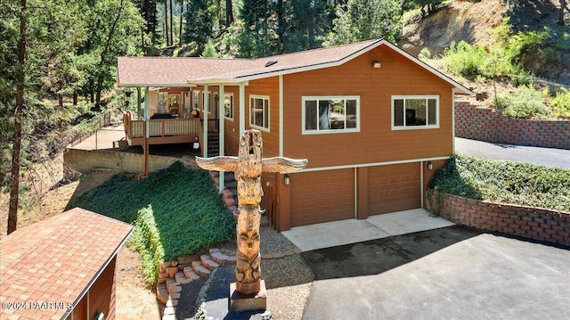 view of front of property with a deck and an attached garage