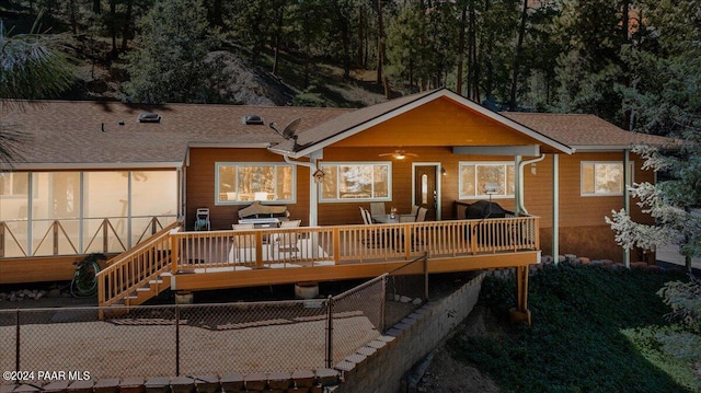 back of property featuring a wooden deck, ceiling fan, stairs, and fence