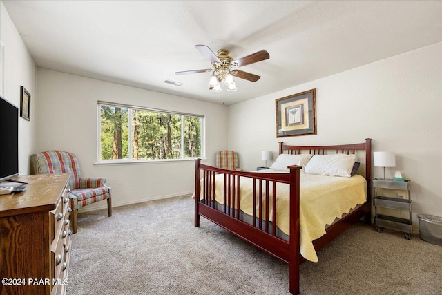 carpeted bedroom with baseboards, visible vents, and ceiling fan