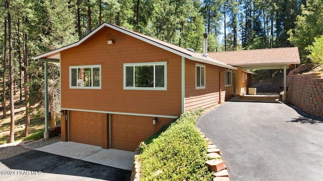 view of front facade with aphalt driveway and a garage