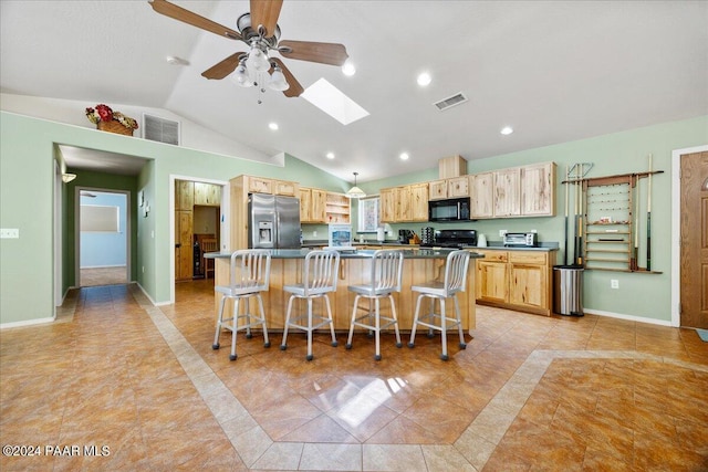 kitchen with visible vents, light brown cabinets, black microwave, and stainless steel fridge with ice dispenser