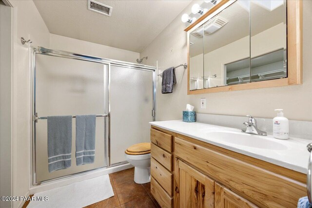 full bathroom featuring tile patterned flooring, visible vents, a stall shower, and toilet