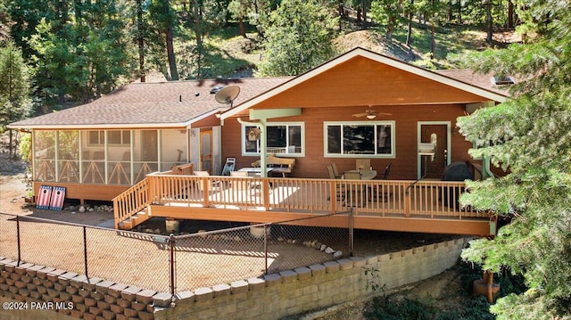 rear view of property with stairway, a ceiling fan, fence, a wooden deck, and a sunroom