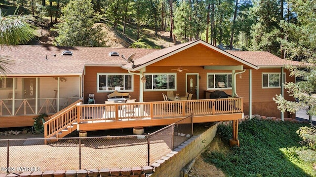 back of property featuring a deck, a ceiling fan, fence, stairway, and a sunroom