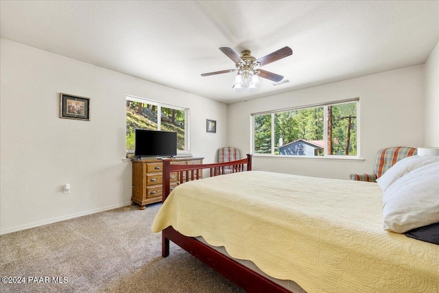 bedroom featuring multiple windows, carpet, visible vents, and baseboards