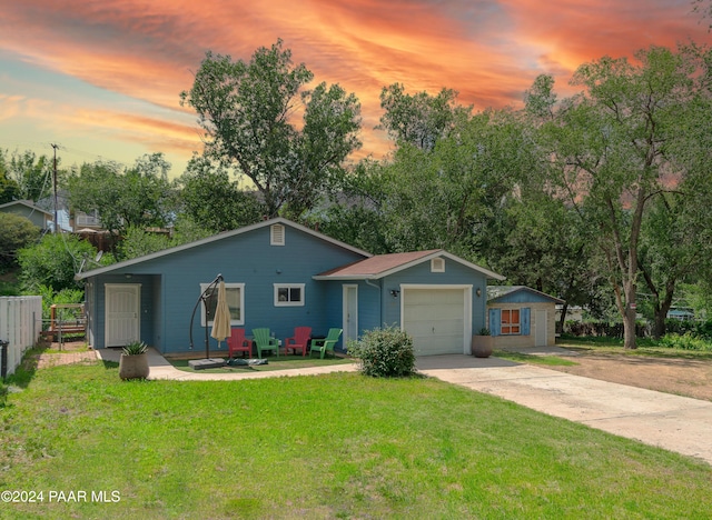 single story home with a lawn and a garage