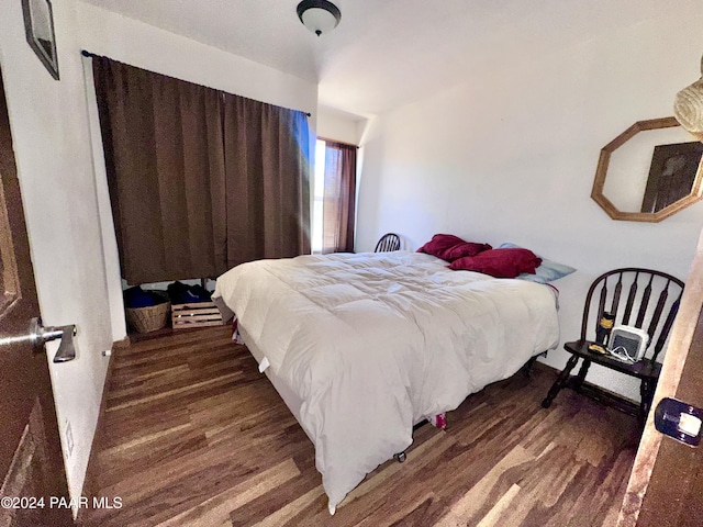 bedroom with dark wood-type flooring