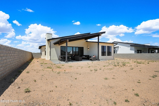 5711 E Hahn St, Prescott Valley, AZ 86314 - back of house featuring stucco siding, an outdoor living space, a fenced backyard, and a patio
