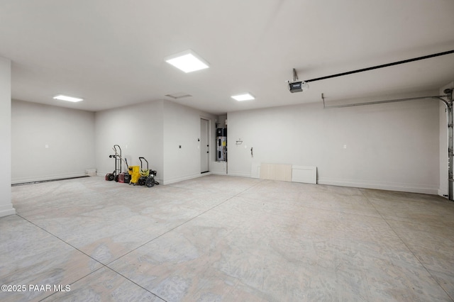 5711 E Hahn St, Prescott Valley, AZ 86314 - garage featuring a baseboard radiator, a garage door opener, and hybrid water heater