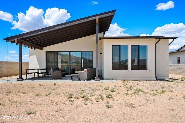 5711 E Hahn St, Prescott Valley, AZ 86314 - rear view of house with stucco siding, a patio, and outdoor lounge area