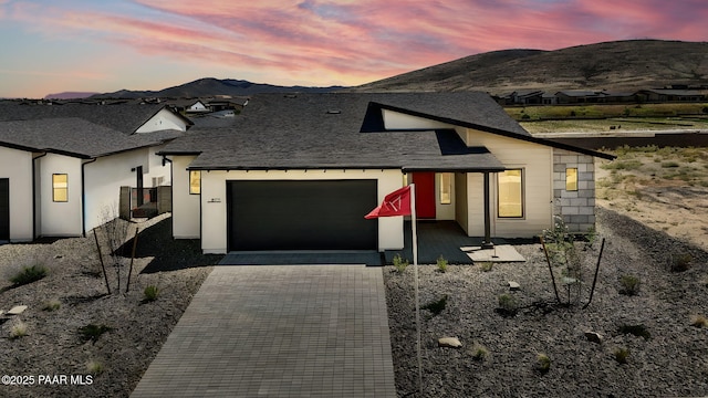 5711 E Hahn St, Prescott Valley, AZ 86314 - view of front of home featuring an attached garage, decorative driveway, and a mountain view