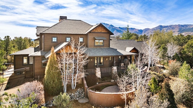 view of front of home featuring a chimney and a mountain view