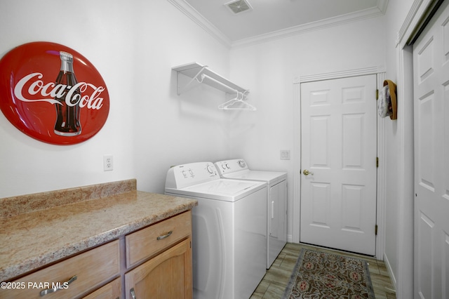 laundry area featuring washer and clothes dryer and ornamental molding