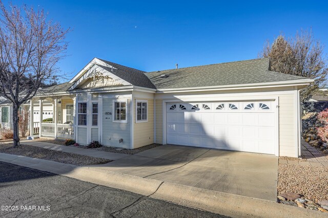 view of front of house featuring covered porch and a garage