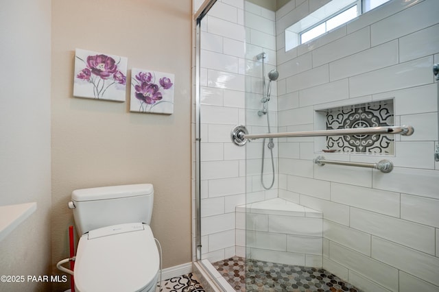 bathroom featuring toilet and tiled shower
